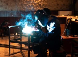 man-with-mask-welding-metal-atelier_23-2149025925